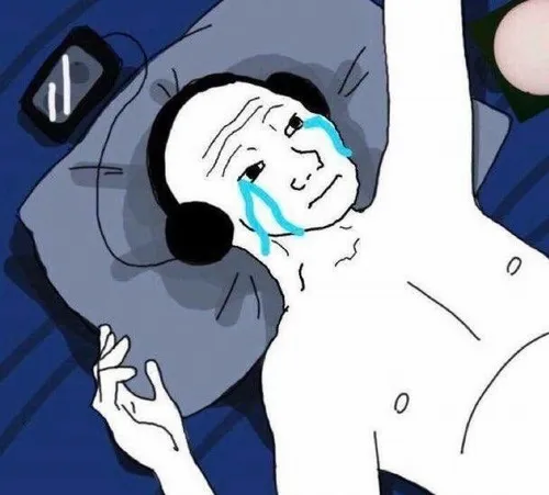 8 Meme buồn bã có chú mèo xám ngồi trong góc phòng, mắt cụp xuống như hiểu hết nỗi mệt của người xem